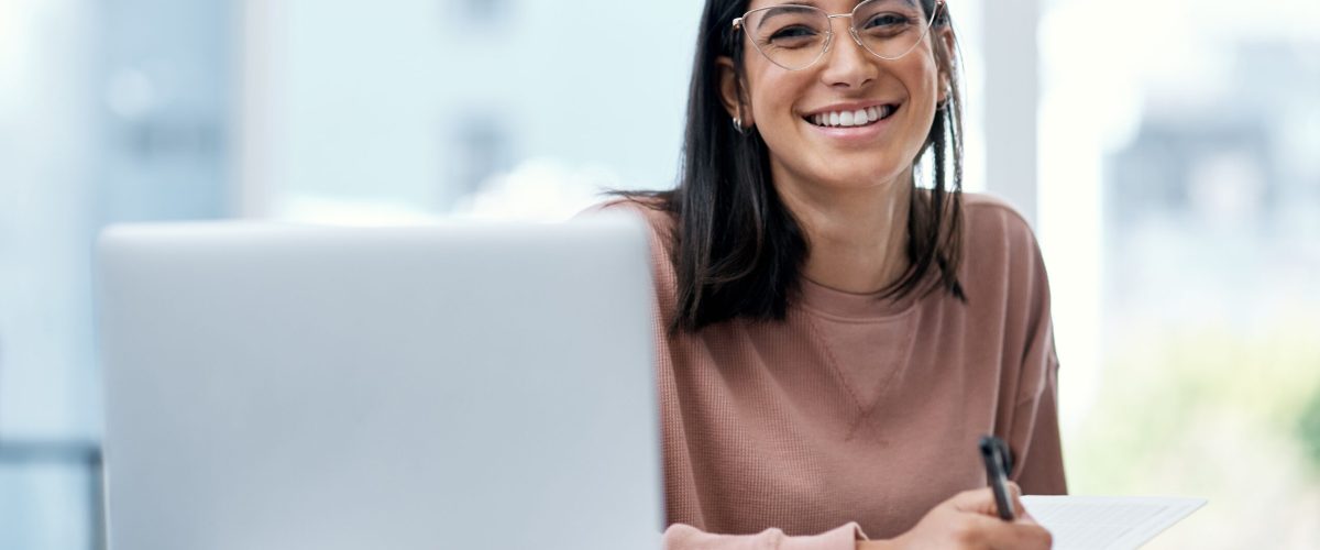 Shot of a confident young woman using a laptop while working from home