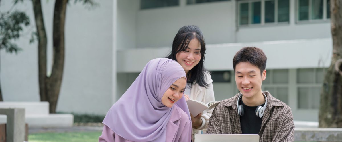 Diverse group of university students brainstorming together outdoors at campus